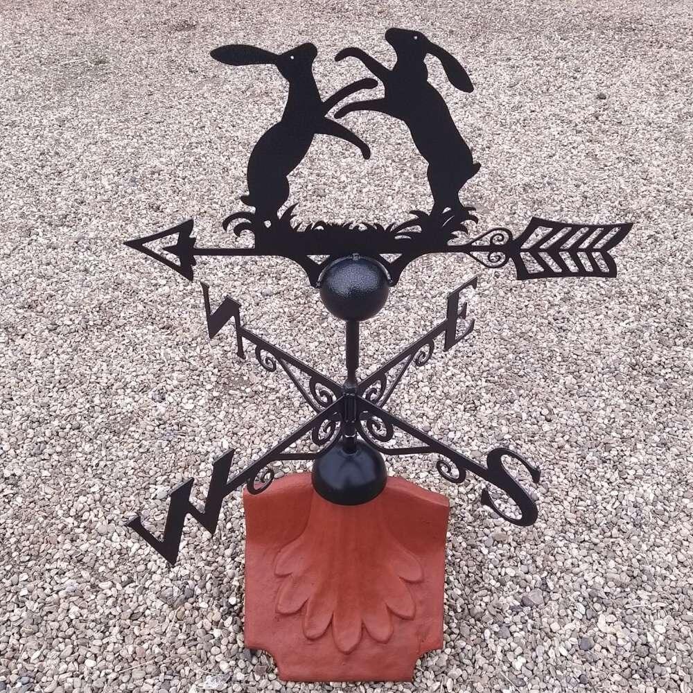 Boxing hares weathervane on a ridge tile fitting with multiple angle ...