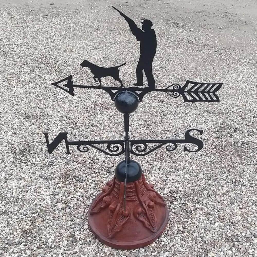 Gun up hunting weathervane fitted on a round ridge tile cap