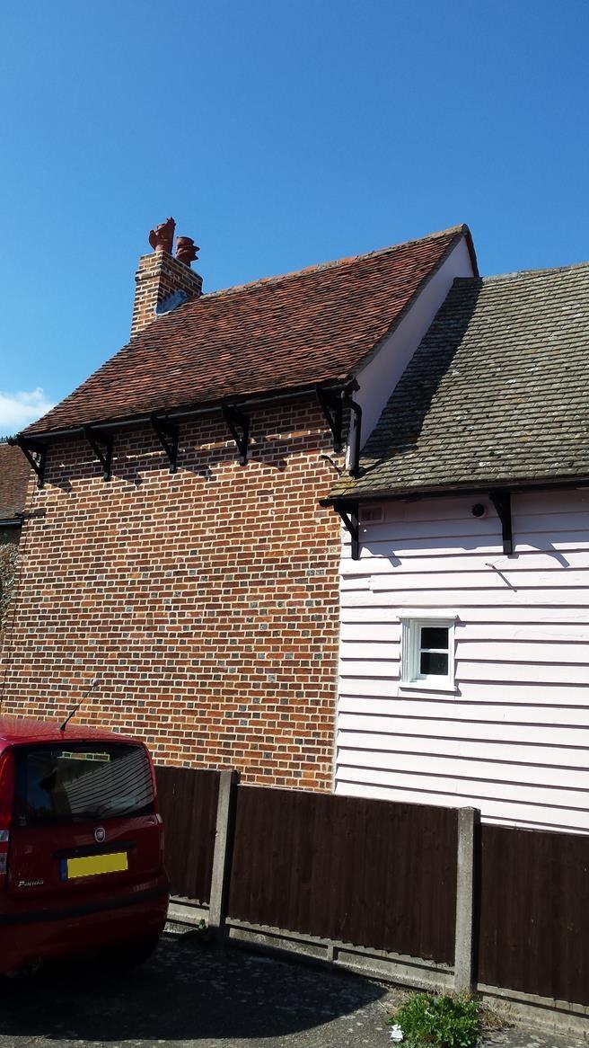 Dragon terracotta chimney pots mounted atop a chimney stack