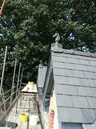 Angled slate grey horse roof finial on gable end