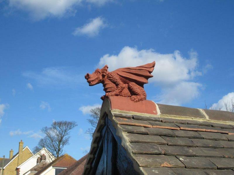 Half round terracotta roof dragon installed on a roof in Kent