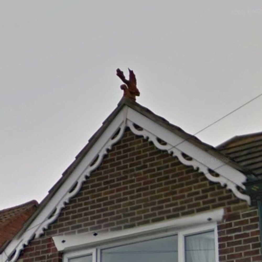 a wyvern finial with an oriental aesthetic installed on a roof