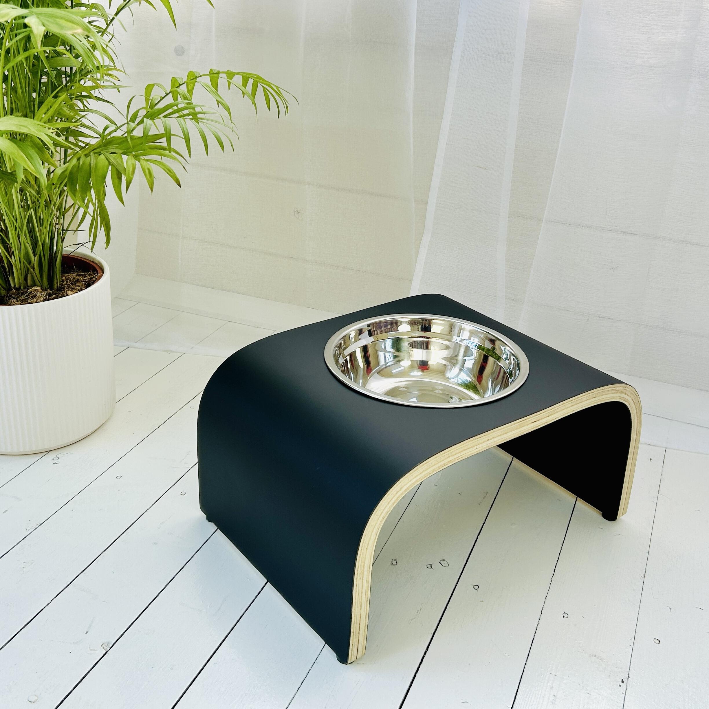 single bowl matt black dog bowl stand on white wooden floor