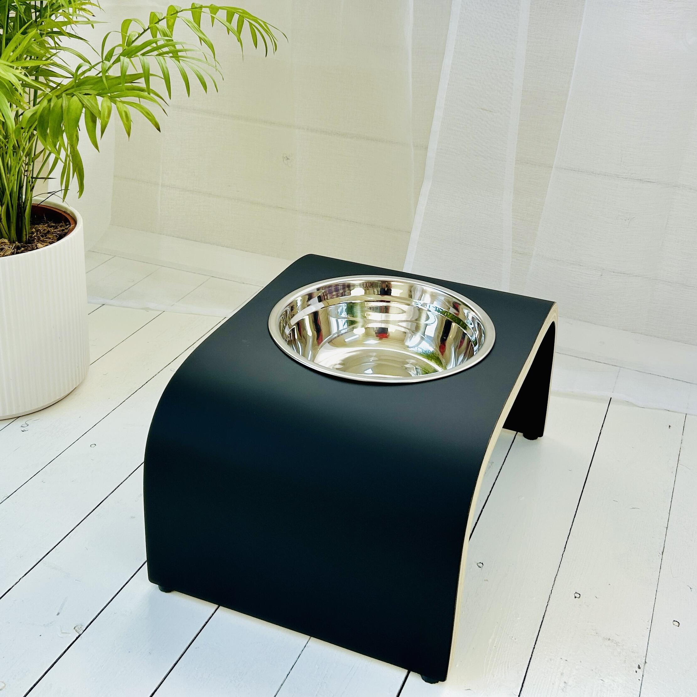 side view of matt black wooden dog bowl stand with stainless steel bowl